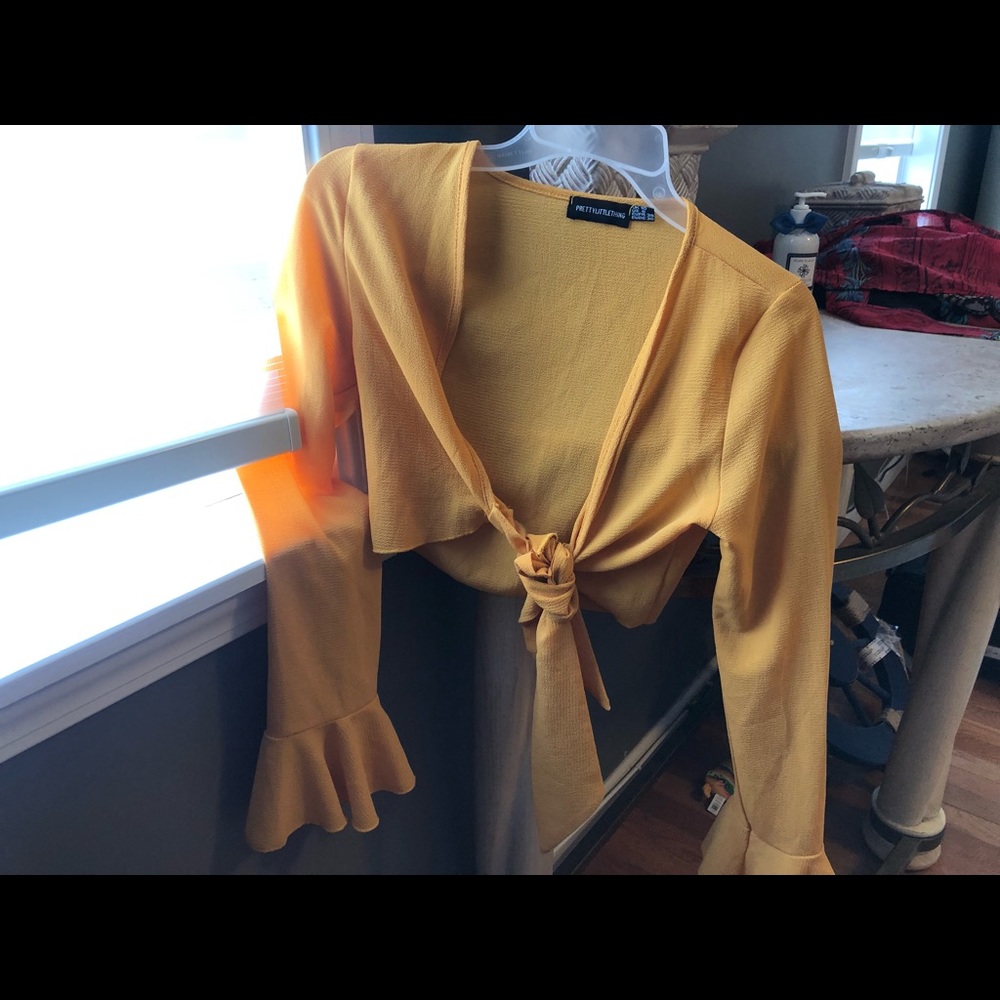 Pretty little thing bright yellow tied cropped blouse with ruffles on end